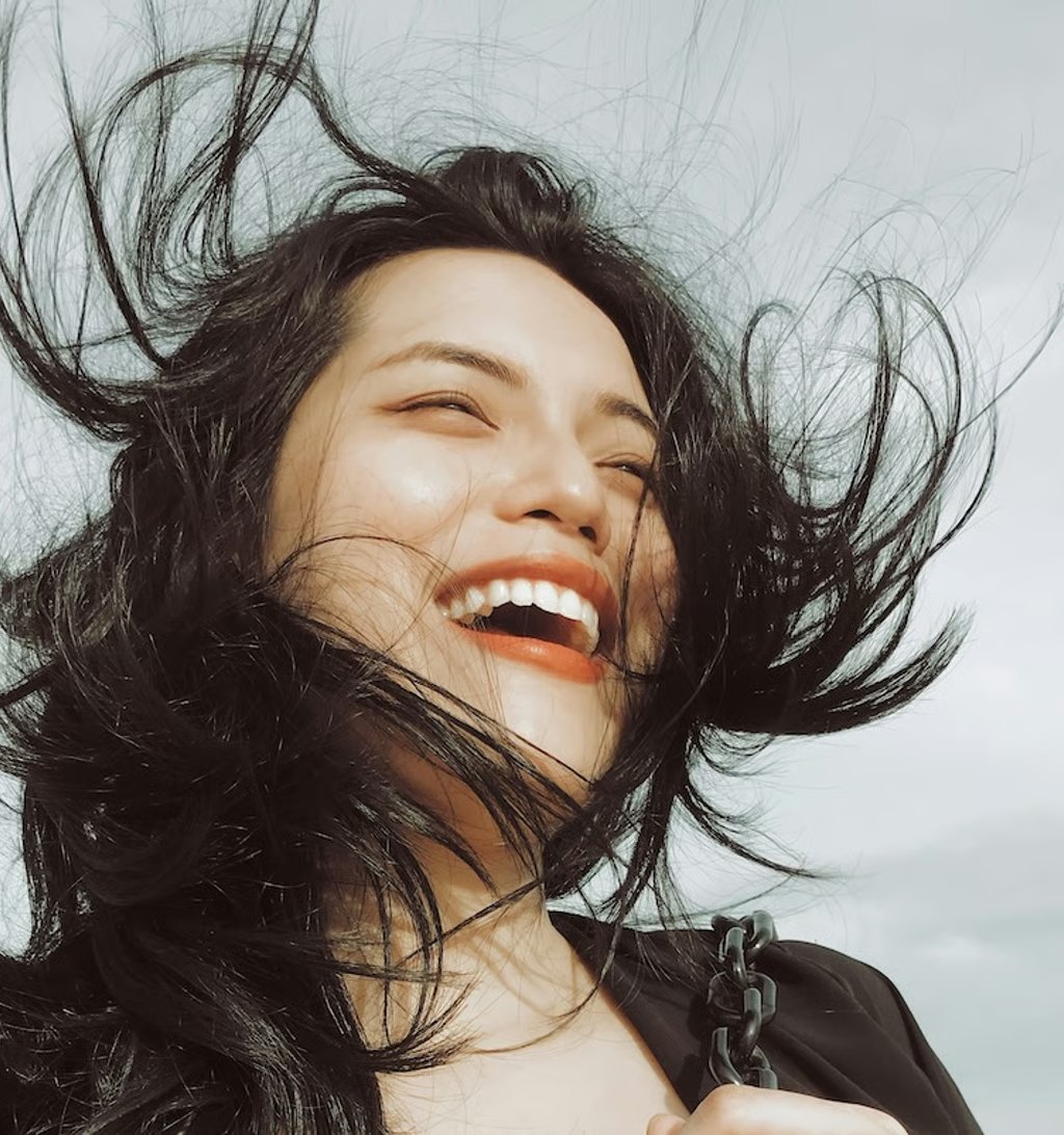 Woman smiling confidently with straight, white teeth